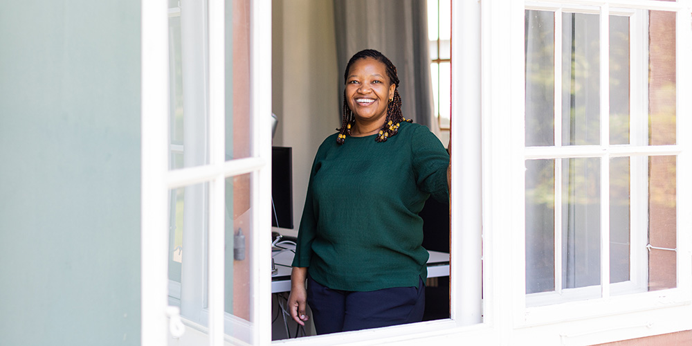 Lerato Posholi at the window in her office
