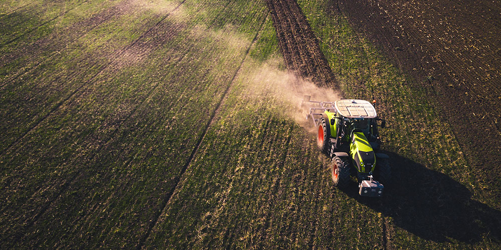 View from above of a tractor tilling a field