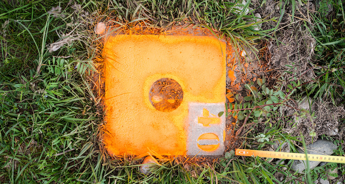 bright orange marking stone dug into the ground