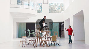 Man climbing on chairs