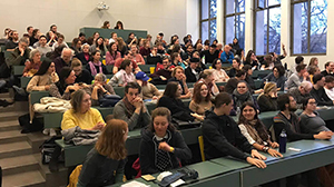 many people sitting in a lecture hall