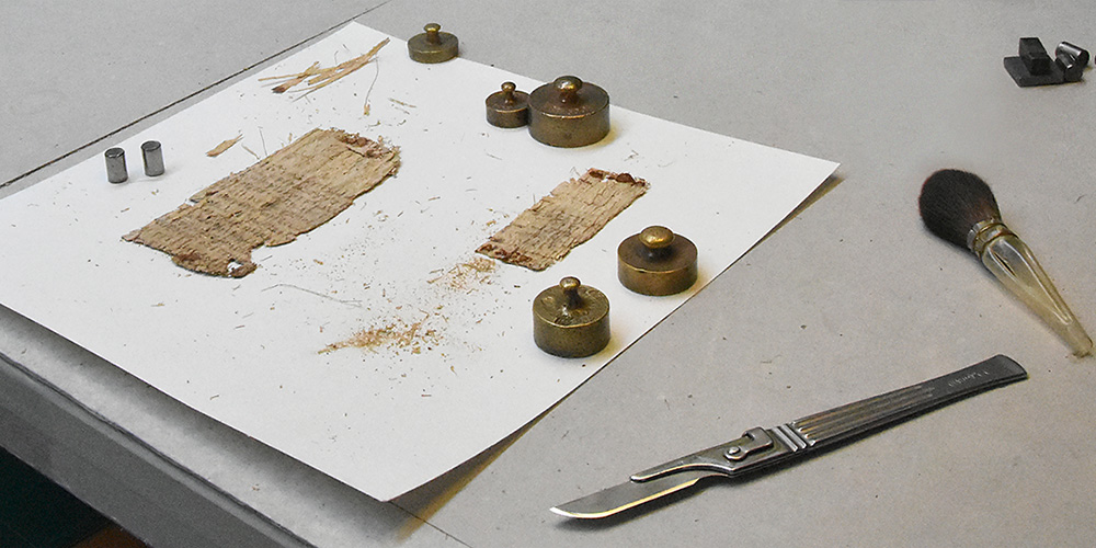 Not high-tech at all: The conservation of papyrus requires above all craftsmanship, expertise and time. A specialized papyrus conservator was brought to Basel to make this 2000-year-old document legible again. (Photo: University of Basel)